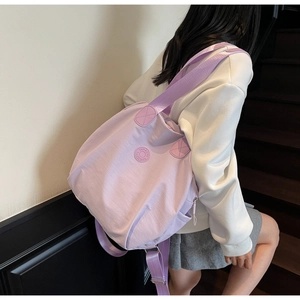 Detaillierte Seitenansicht des helllila Nylon-Rucksacks am Modell in minimalistischer Umgebung