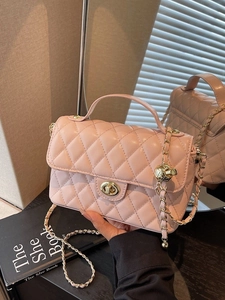 Elegant light pink quilted crossbody bag with gold chain strap and top handle