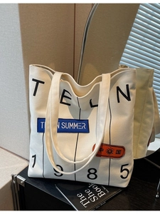 Off-white large canvas tote bag with TELN 1985 print and colorful embroidered patches