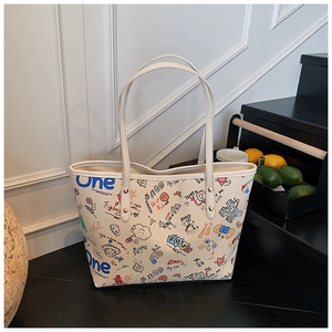 Detail of graffiti tote bag with colorful prints and sturdy gold metal rivets on straps