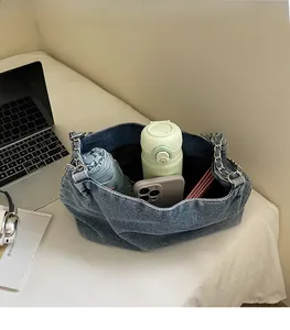 Spacious denim tote bag interior showing large capacity for umbrella and thermal bottle