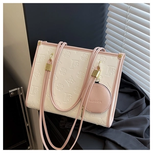 Detail of floral embossed cream tote bag with pink trim and matching coin purse