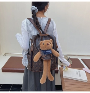 Detail of printed leather backpack featuring a 3D plush bear and lazybreeze scarf detail