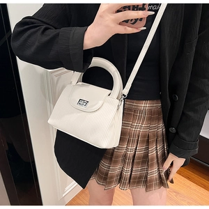 White pleated faux leather crossbody bag with silver buckle and elegant top handle strap