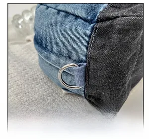 Close-up of blue denim patchwork bag with premium silver D-ring metal hardware detail