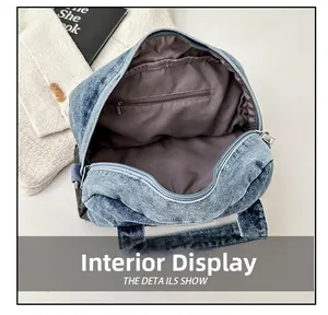 Internal view of denim crossbody bag showing fabric lining and zipper pocket detail