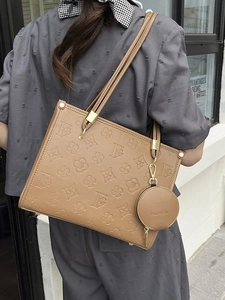 Brown monogram tote bag set with detachable round pouch shown on a fashion model
