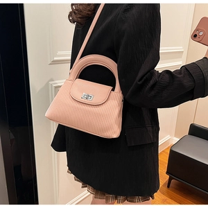 Pink quilted crossbody bag featuring elegant vertical textures and a metal twist lock detail