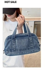 Detailed view of casual blue denim handbag with front pocket and sturdy strap