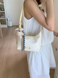 White leather hobo tote bag with yellow trim and cute plush bear charm for women
