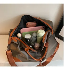 Detail view of the spacious inner compartment with travel essentials and leather handles
