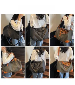 Large travel tote in black and olive green with brown leather handles and shoulder straps
