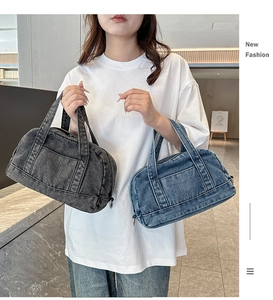 Detail showing two large capacity denim tote bags in blue and dark gray with front pockets