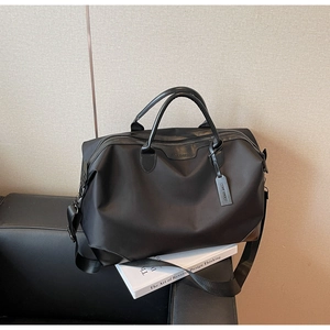 Macro shot of waterproof black travel bag with sturdy handles and metallic zipper detail