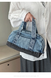 Detailed view of large denim tote bag featuring vintage patchwork and dual top handles