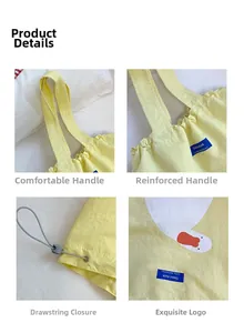 Detail of yellow canvas tote bag showing reinforced handles and cartoon duck print