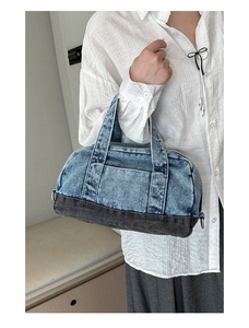 Detail of vintage denim pillow bag with light blue and dark grey patchwork design