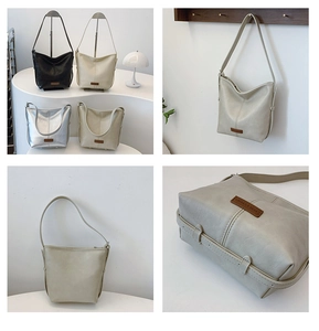 Detail view of minimalist bucket bags in three colors with refined stitching and logo