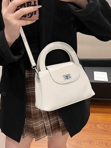 Elegant white quilted crossbody bag with silver twist lock and round handle for women