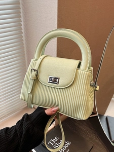 Quilted light green crossbody bag with silver twist lock and vertical textured details