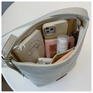 Macro shot of the spacious inner compartment and pocket of the leather bucket bag