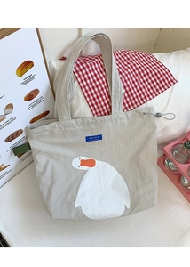 Detail of canvas tote bag showing white duck illustration and blue Dazui duck label