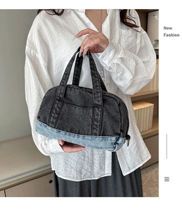 Detail showing the two-tone patchwork denim design and vertical stitching on the handbag