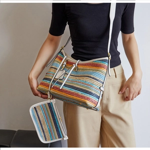 Détail du sac hobo tissé à rayures colorées avec bandoulières en cuir blanc et boucles