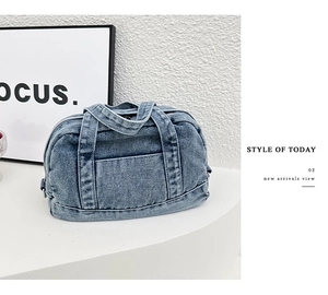 Close-up of light blue washed denim handbag with front pocket and sturdy top handles