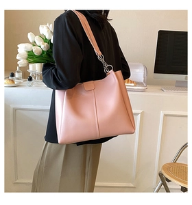 Detail of soft pink PU tote bag with silver ring hardware and premium textured finish