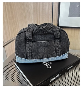 Detail of creative denim handbag with unique shirt-collar design and patchwork texture
