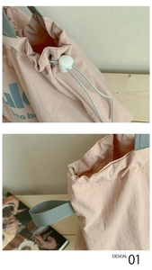 Nahaufnahme der rosa Kordelzug-Tasche mit grauen Griffen und weißem Verschluss