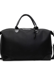 Black large capacity travel bag made of durable nylon with leather handles and strap