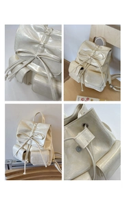 Detail of cream backpack showing glossy wrinkled texture and bow ribbon magnetic closure