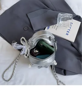 Interior view of silver textured backpack showing phone and perfume bottle storage