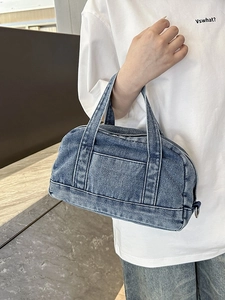 Light blue denim tote bag with dual handles and front pocket for casual styling