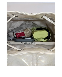 Detail of drawstring backpack interior showing spacious storage and herringbone fabric lining