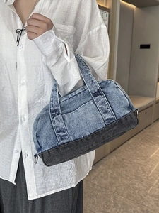 Blue and gray patchwork denim cylinder handbag with vintage wash and dual handles