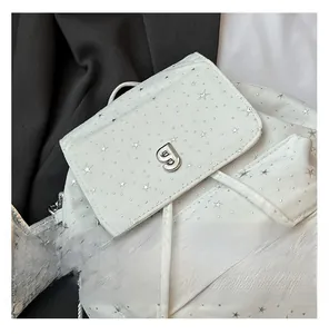 Close-up of white nylon backpack featuring silver star prints and a metal G hardware detail