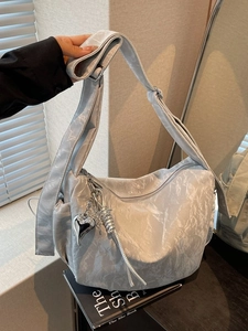 Minimalist light grey wrinkled fabric crossbody bag with heart pendant and wide strap