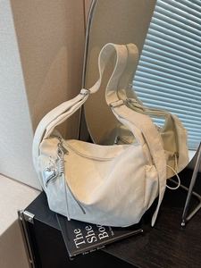 Minimalist white dumpling shoulder bag with silver heart and butterfly charms