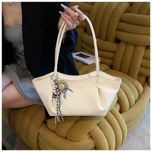 Detail of off-white tote bag in pebble leather with woven texture sofa and hat charm