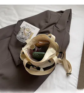 Canvas cross-body bag interior showing large capacity for phone and cosmetics