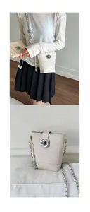 Detail of cream woven bucket bag featuring a large silver round lock and chain strap
