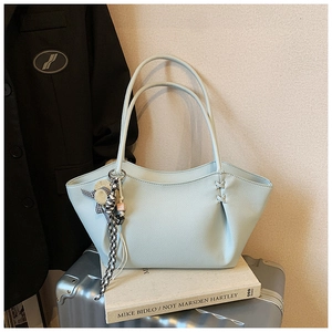 Light blue lychee texture tote bag featuring a cross-stitch detail and straw hat charm