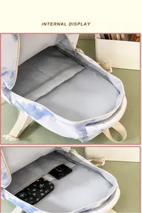 Macro view of blue tie-dye backpack showing dual main compartments and laptop sleeve