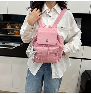 Pink canvas backpack with silver star sequins and adjustable straps shown in detail