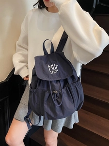 Minimalist nylon travel backpack with drawstring and MUTING embroidery in dark blue