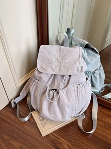Minimalist light purple nylon backpack with drawstring closure and silver straps