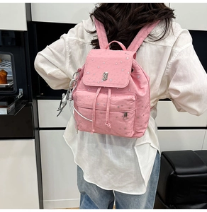 Pink nylon backpack with silver star patterns, metal G logo and animal charm detail